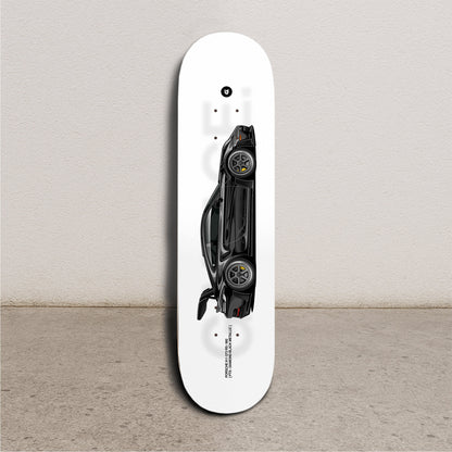 Skateboard deck with a black car design on a white background